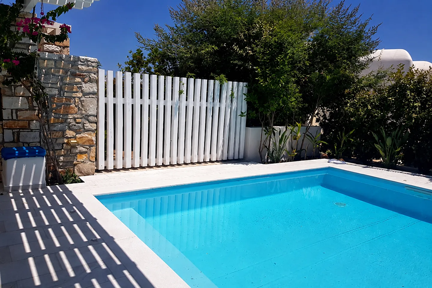 Villa Nausithoe private pool with white fence