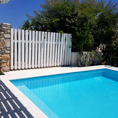 Villa Nausithoe private pool with white fence